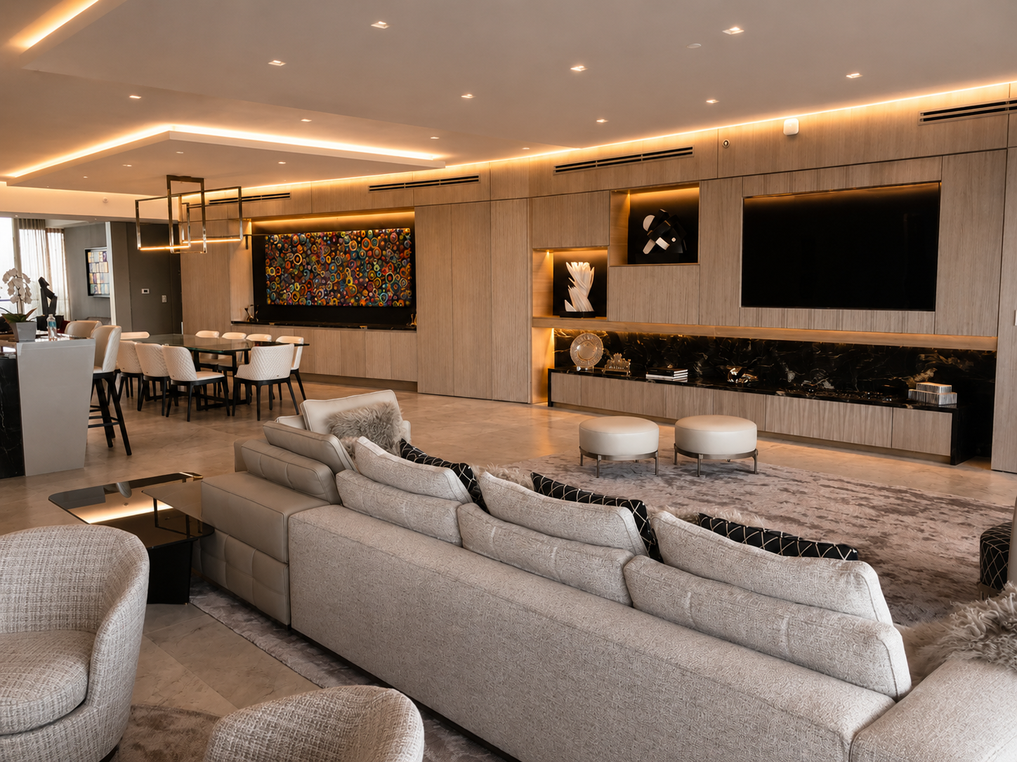 Wide view of penthouse living area, dining, and integrated wall system