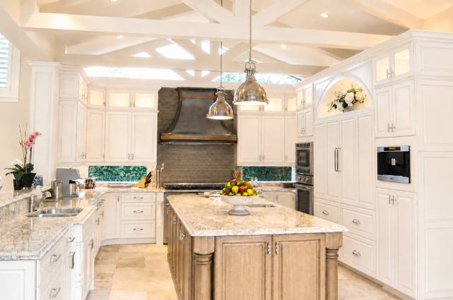 Custom kitchen with large island, classic millwork, and pendant lighting